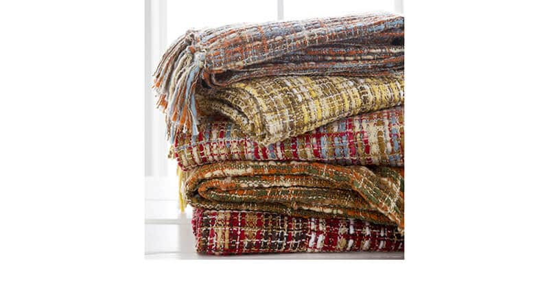 A stack of warm plaid blankets by Surya